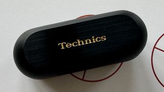 Technics EAH-AZ100 in-ear headphone case on white surface