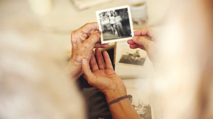 A mom and daughter look at family photos.