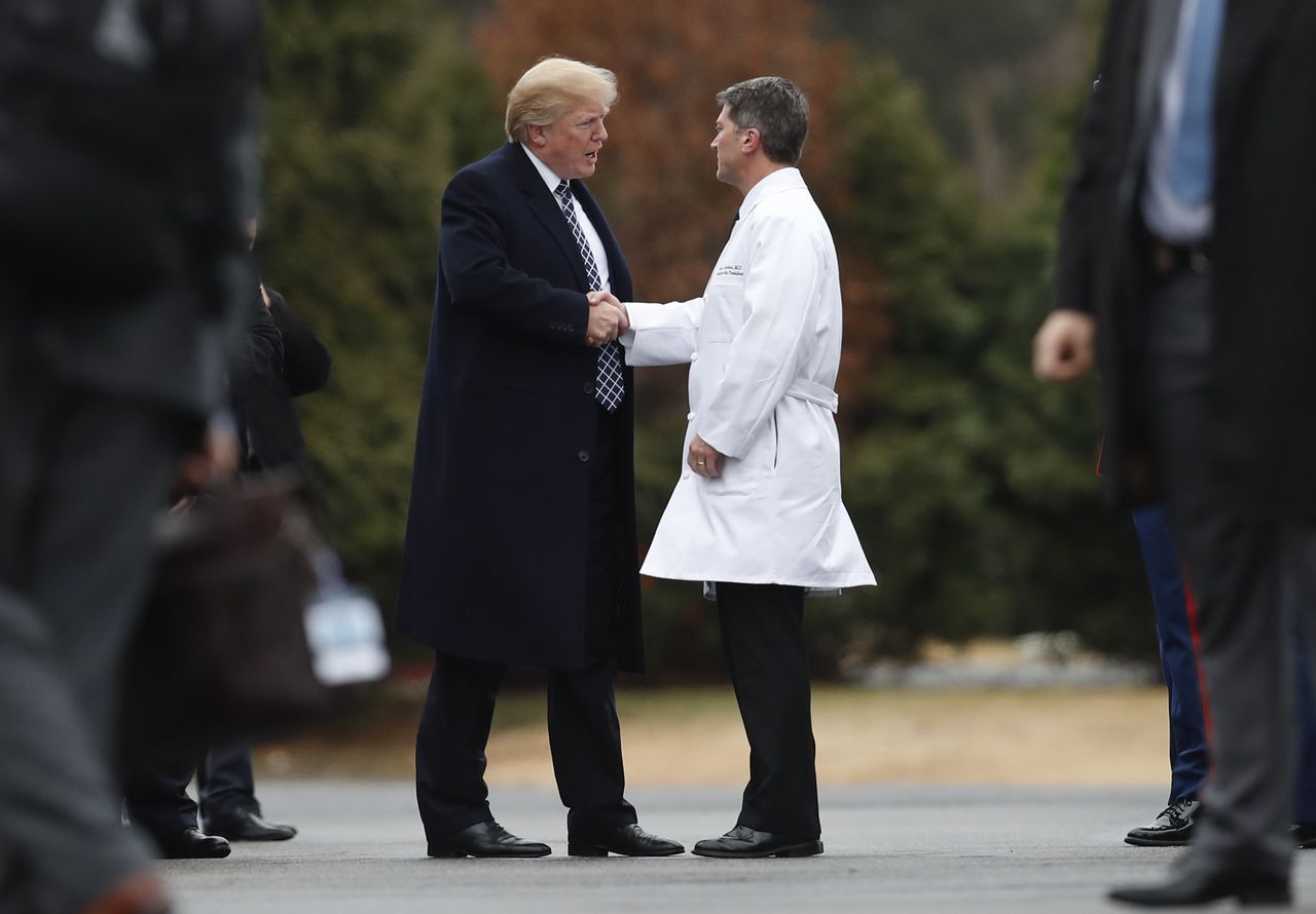 President Donald Trump shakes Dr. Ronny Jackson&amp;#039;s hand.