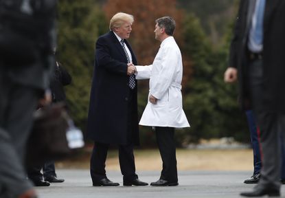 President Donald Trump shakes Dr. Ronny Jackson's hand.