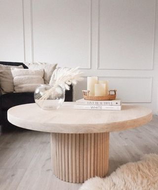 Fluted DIY coffee table with coffee table books, fishbowl vase and pampas