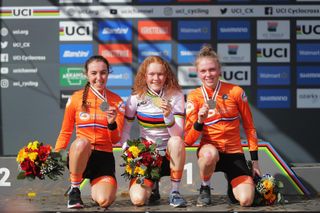 Women's U23 podium at 2022 UCI Cyclo-cross World Championships saw Puck Pieterse with rainbow jersey (middle) and Fem van Empel with bronze (right)