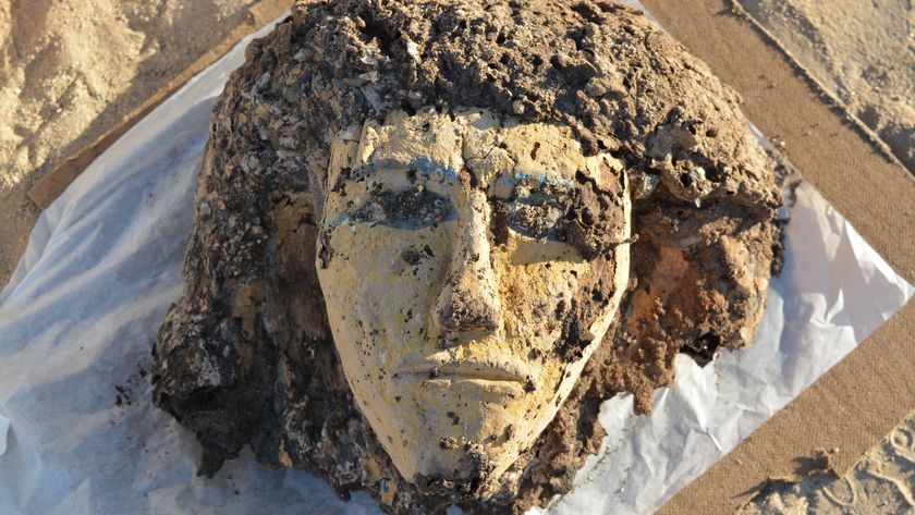 a close-up of a weathered wooden face from a coffin