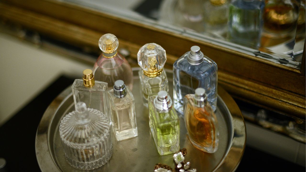 A collection of perfumes on a dressing table 