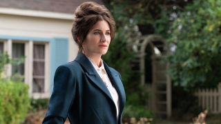 Kathryn Hahn's Agatha Harkness standing in front of a house