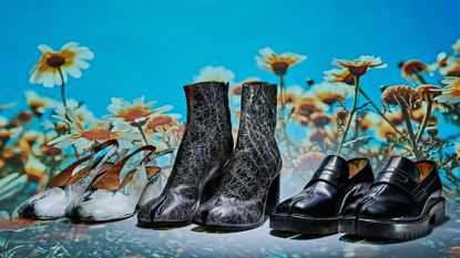 Two pairs of Maison Margiela 'Tabi' footwear on flower background