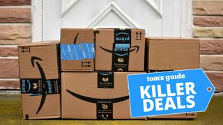 Amazon delivery boxes stacked outside a front door with a Tom's Guide deal tag