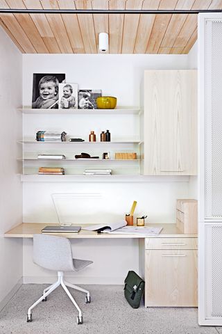 Closet office with white decor and sliding door
