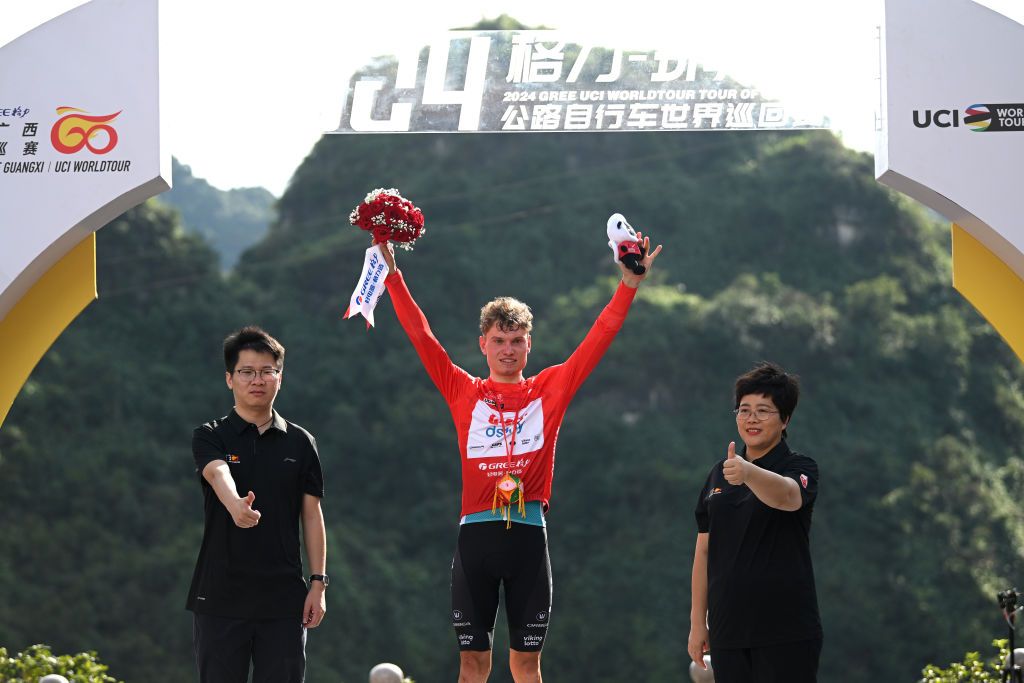 NONGLA CHINA OCTOBER 19 Lennert Van Eetvelt of Belgium and Team Lotto Dstny celebrates at podium as Red Leader Jersey winner during the 5th GreeTour Of Guangxi 2024 Stage 5 a 1658km stage from Yizhou to Nongla 641m UCIWT on October 19 2024 in Nongla China Photo by Dario BelingheriGetty Images
