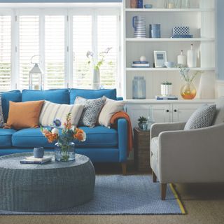 blue living room with blue sofa and grey armchair