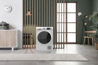 A hotpoint heat pump tumble dryer in a room