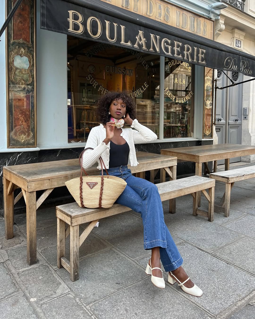 Influencer Emmanuelle Koffi wearing heeled Mary-Janes and jeans.