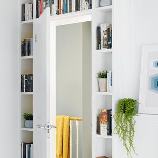 Built in storage shelving around and above bedroom door