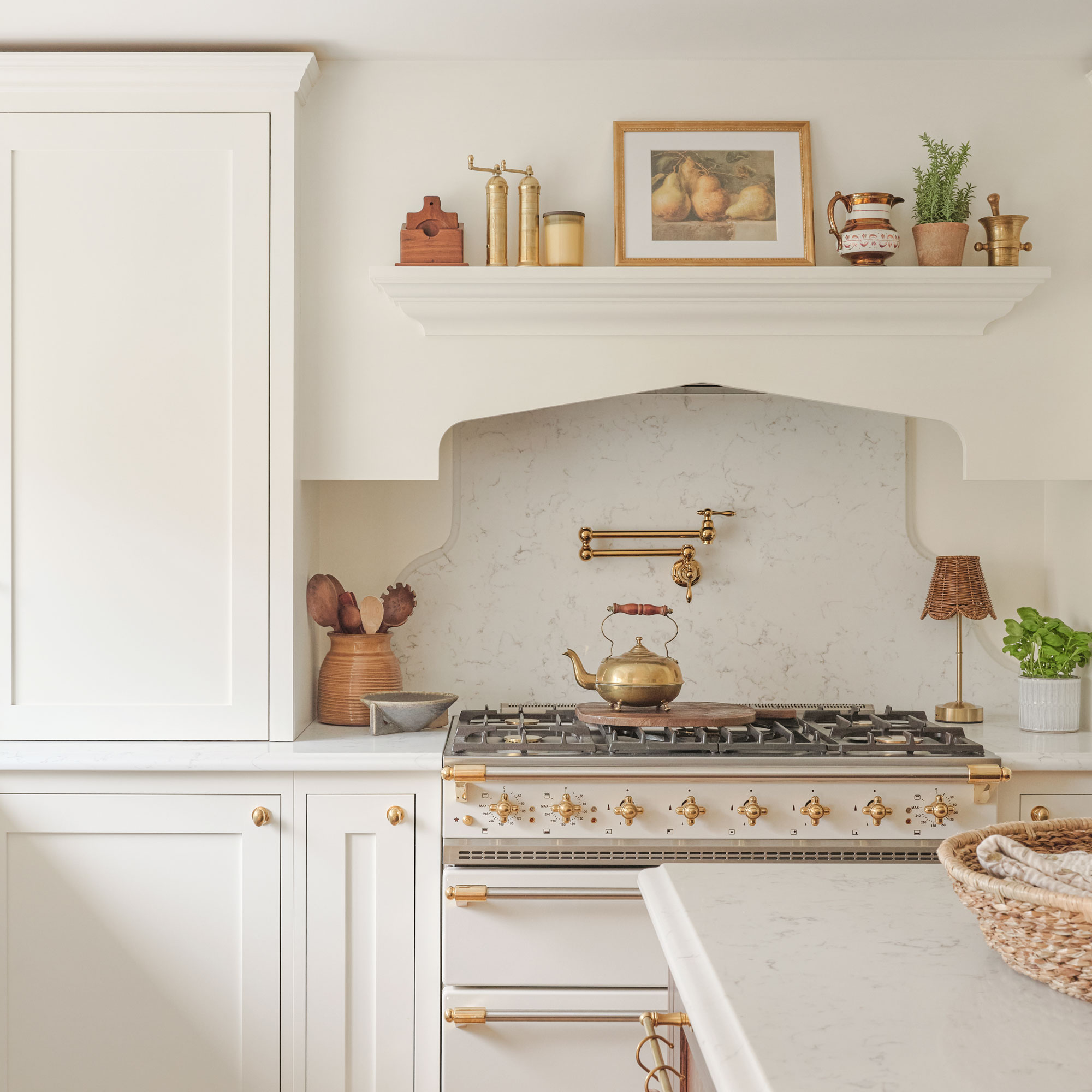 Off-white kitchen walls with white cabinetry and a white cooker