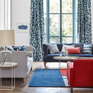 Blue, red and stripe sofa in white living room