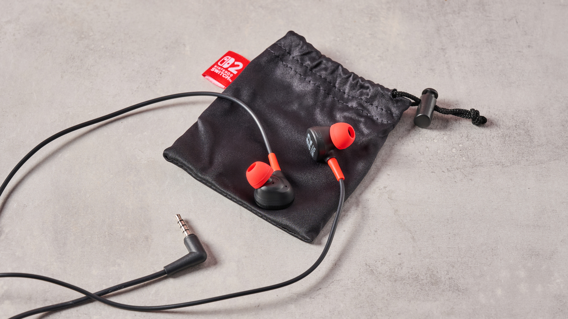 PowerA Wired Earbuds for Nintendo Switch 2 sitting on included carry case