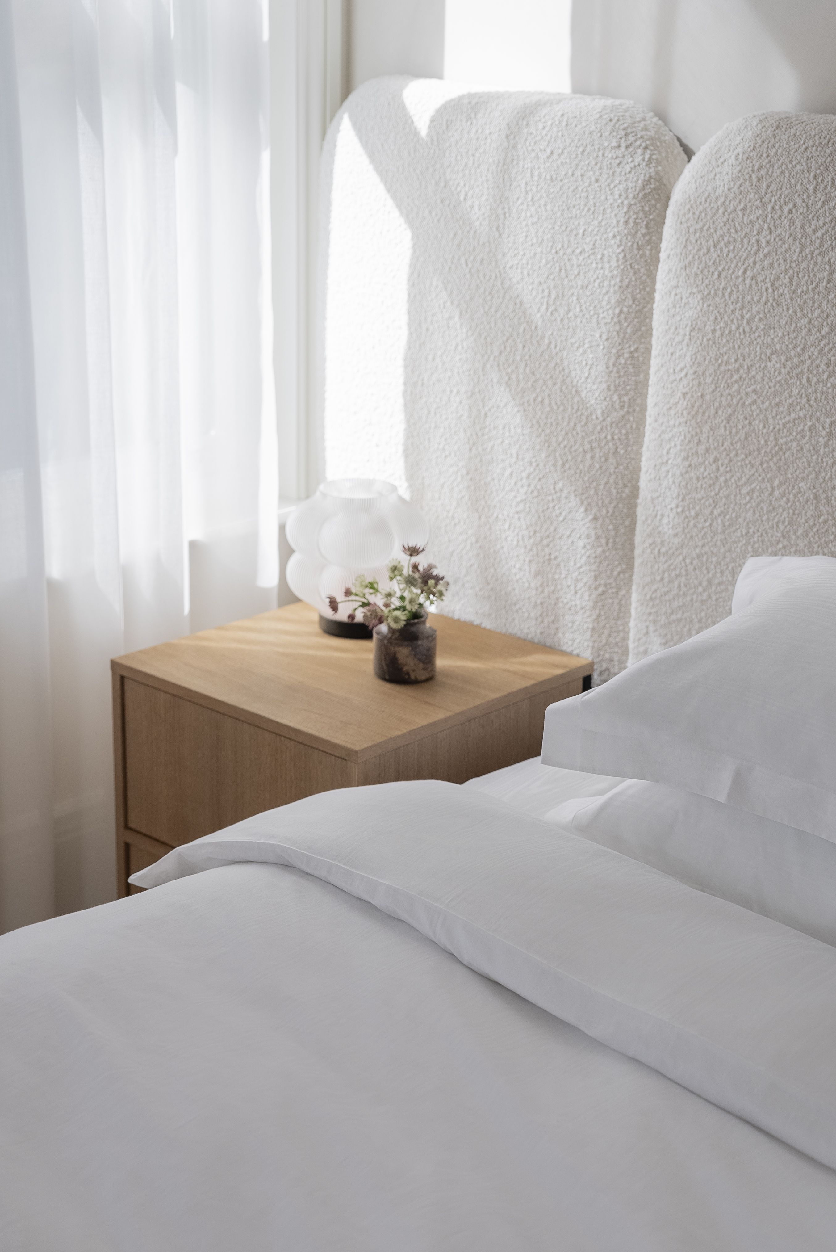 white bedding in a white bedroom