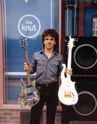 Rusan with a white Cloud guitar and a clear-bodied guitar built for Prince guitarist Wendy Melvoin featuring silk flowers in a slab of cleat Lucite and a Rickenbacker neck converted to a bolt-on. "Wendy thought it was too heavy and returned it to the store," Rusan says. It now resides in the Hard Rock Cafe Museum.