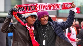 Manchester United and Liverpool half-and-half scarf ahead of a game between the two rivals at Old Trafford in April 2024.
