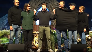 Brennan Lee Mulligan stands on stage with Travis Willingham, Matt Mercer, Chris Perkins and Jeremy Crawford (in a single hoodie), and Marisha Ray - announcing he'll be the new GM for the next campaign of Critical Role.