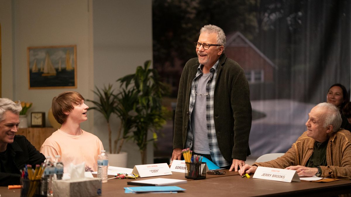 Clay (Johnny Knoxville), Zach (Calum Worthy), Gordon (Paul Reiser), and Jerry (Lawrence Pressman) sitting around a table in Reboot