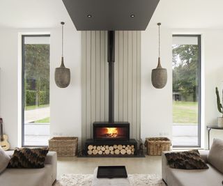 A contemporary log burner with symmetrical hanging pendant lights