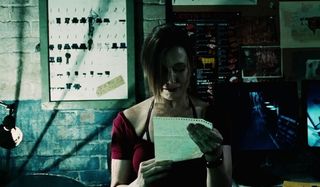 Shawnee Smith reading a blackmail letter in Saw VI.