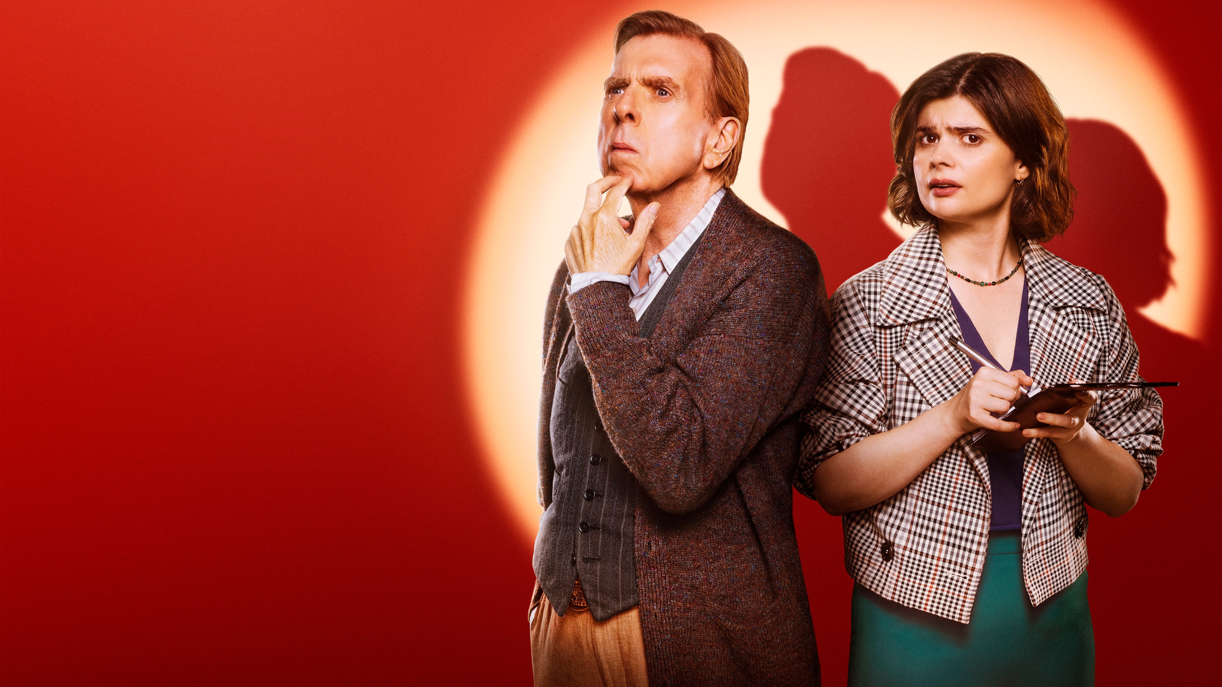 An image of John Chapel (Timothy Spall) and DS Janie Mallowan (Gwyneth Keyworth( standing in a spotlight, with a red tint to the area around them that isn&#039;t in the glare of the light. John is touching his chin with his fingers in a thoughtful fashion, and Janie is writing in a police notebook that she holds in her hands.