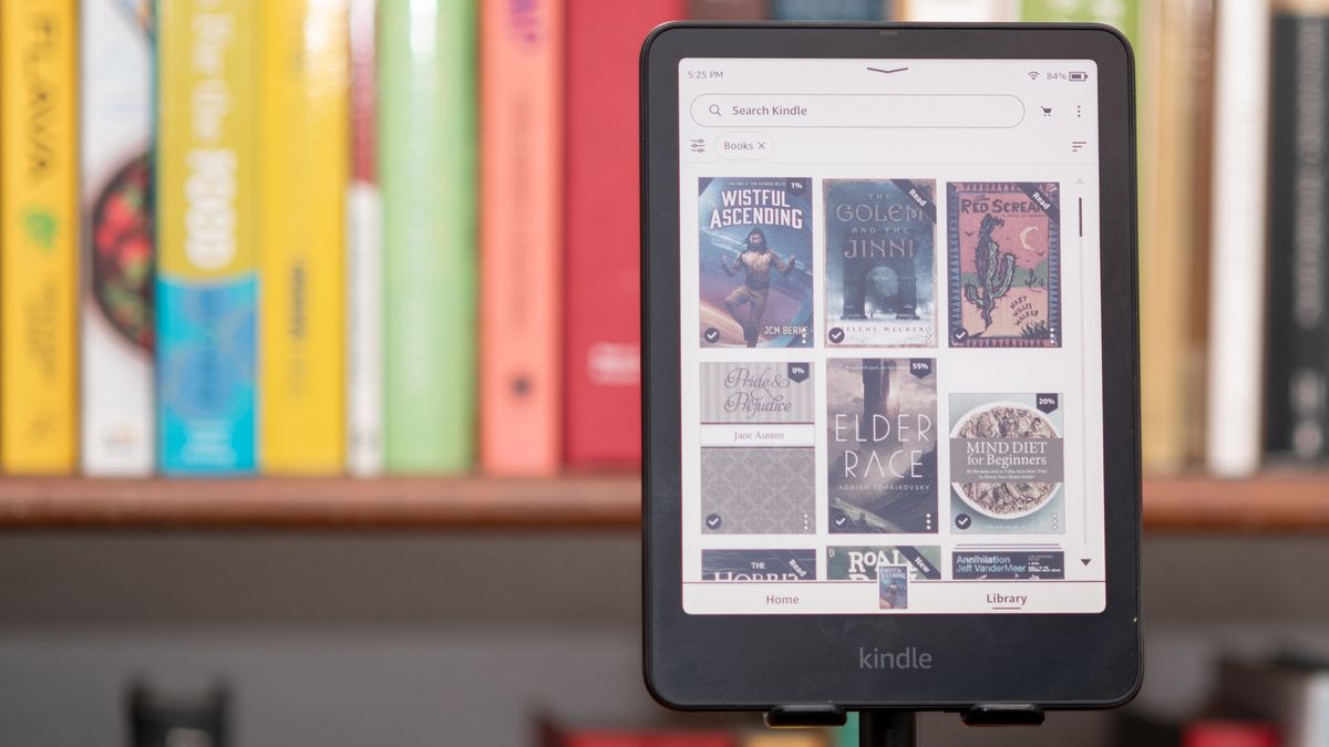 Amazon Kindle Colorsoft Signature edition e-reader showing graphic novels, cookbooks, and fiction, as well as settings