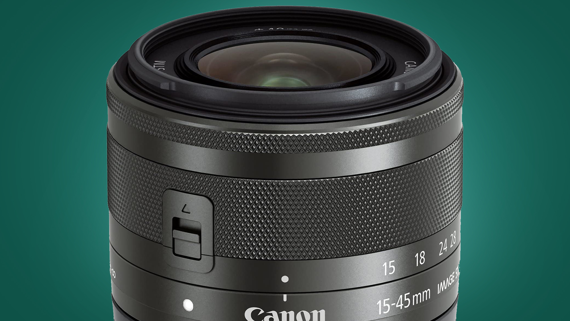 The Canon EF-M 18-45mm lens on a green background