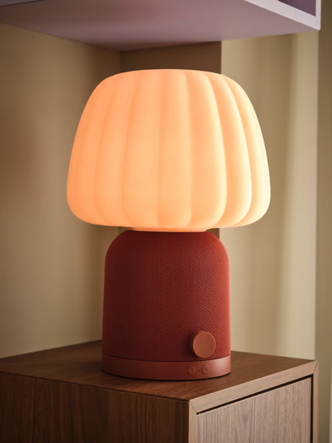 A rust colored IKEA lamp and speaker