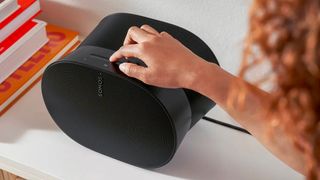 Sonos Era 300 in black with female model using touch controls