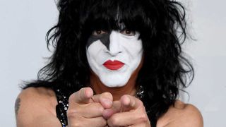 Paul Stanley in make-up pointing at the camera