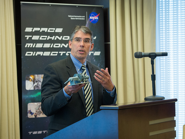 Michael Gazarik Holds Model Green Thruster 