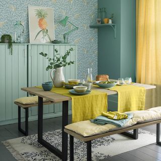 Country dining room with block print wallpaper and yellow curtains