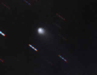 In this Gemini Observatory image, the possible interstellar comet can be seen as it streaks across the night sky.