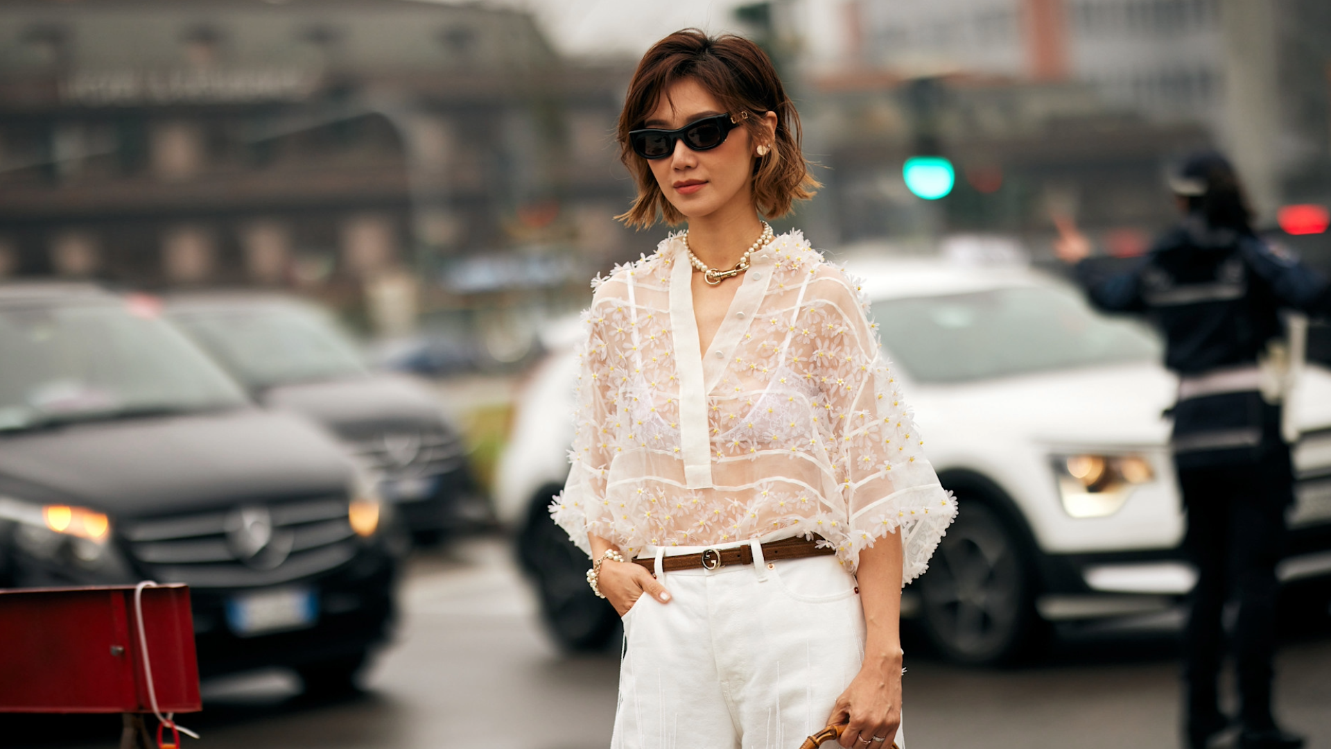 woman wearing sheer white top and white jeans in Milan, italy.