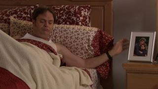 Dwight waking up in bed in The Office