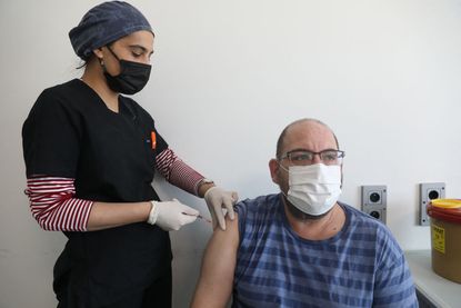 Man receives Pfizer vaccine