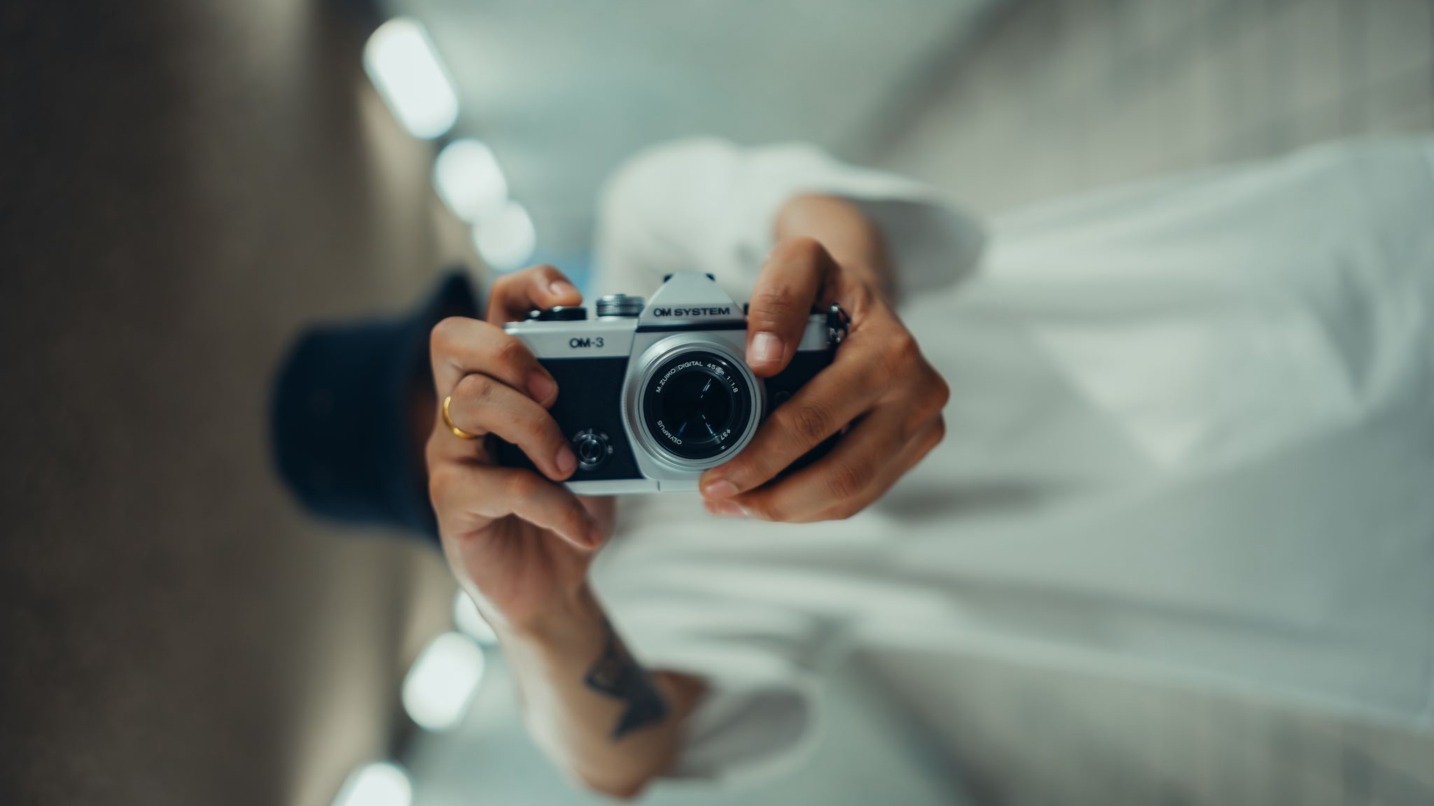 OM System OM-3 being held by a photographer