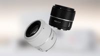 A pair of camera lenses: one black, one white.
