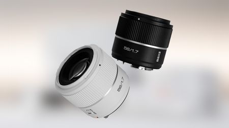 A pair of camera lenses: one black, one white.