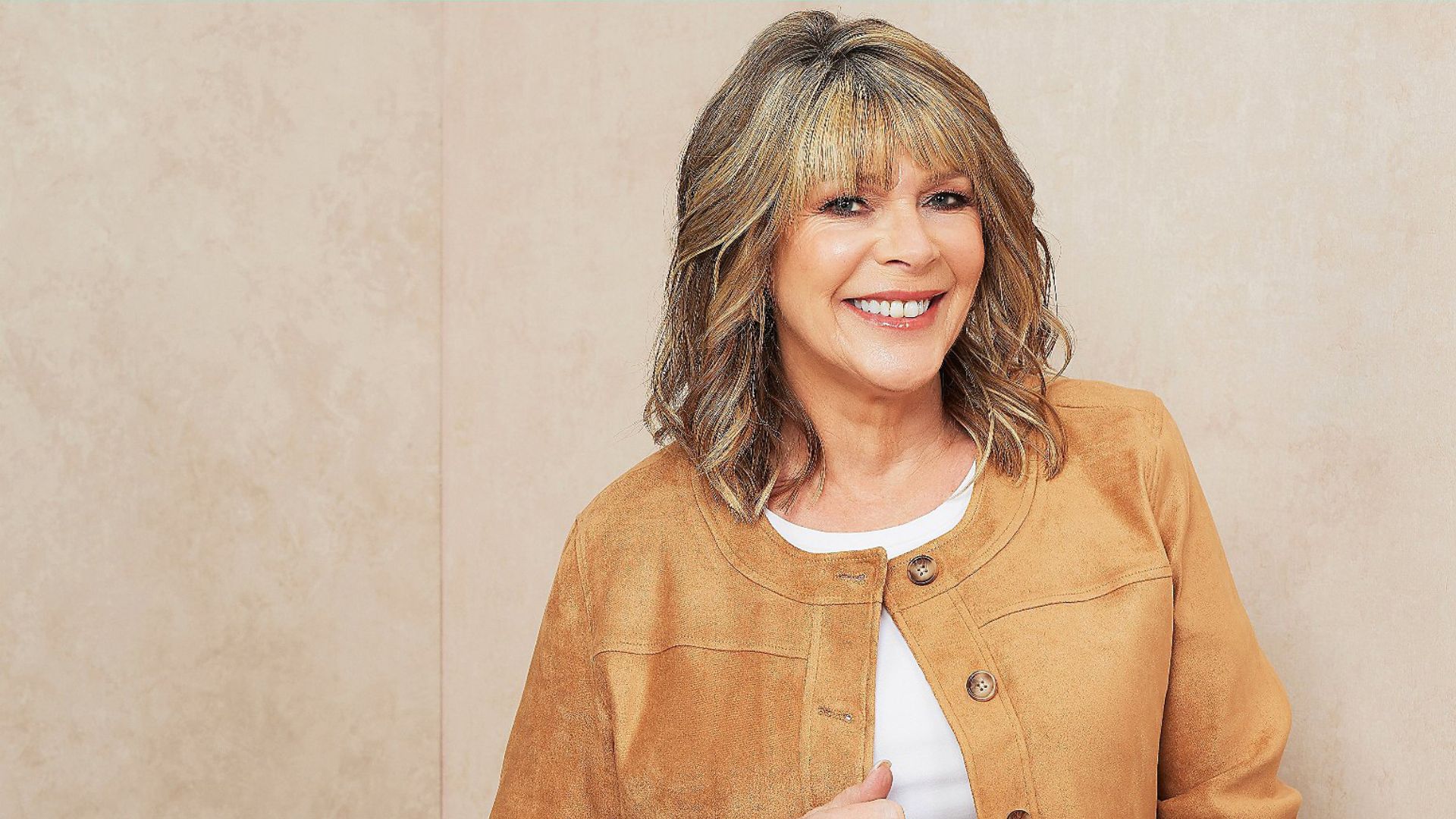 QVC x Ruth Langsford modelling a brown suede jacket