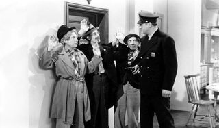 Groucho Harpo and Chico at gunpoint of police officer in The Big store