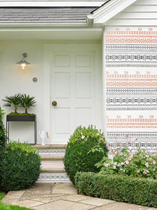 front porch with painted pattern on steps and cladding