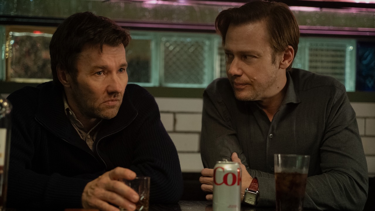 Joel Edgerton sitting next to Jimmi Simpson in Dark Matter