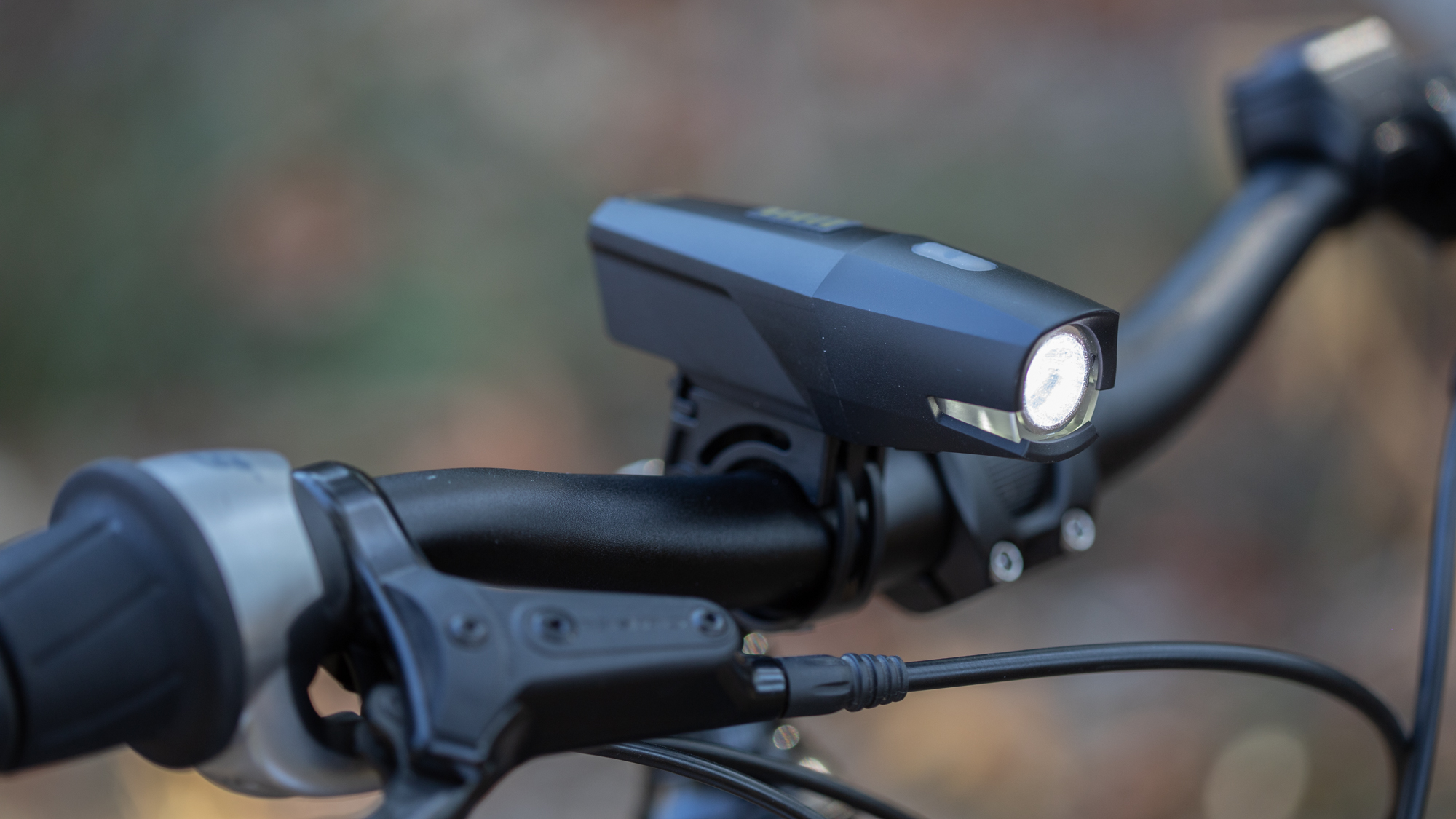 Portland Design Works City Rover Power 700 front bike light mounted to a commuter bike handlebar