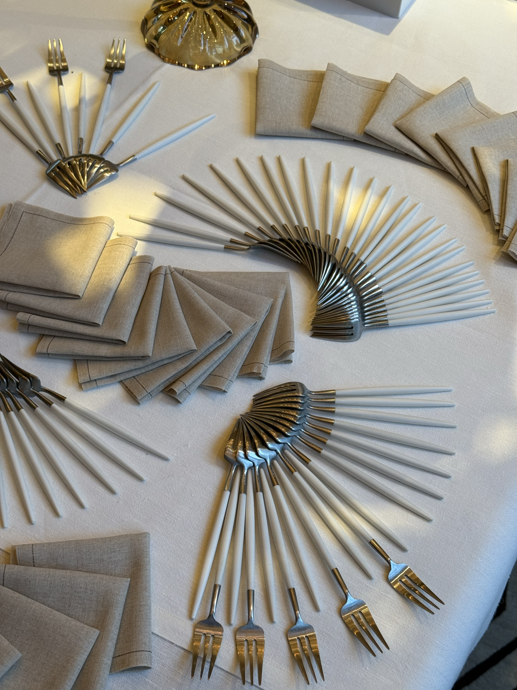 cutlery laid out in intricate ways on a table