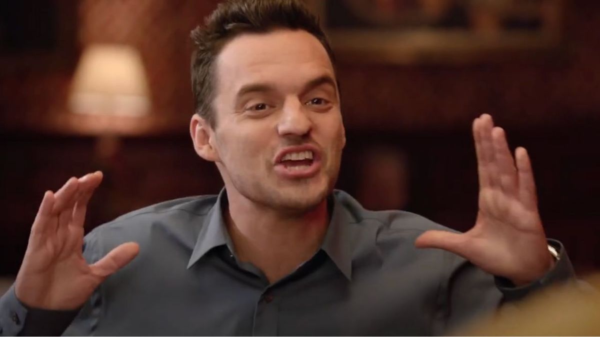 Nick Miller in a blue collared shirt with his hands up in New Girl Season 7