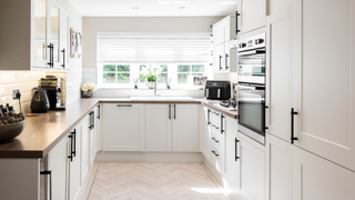 Kitchen with beech chevron-patterned wooden floor boards